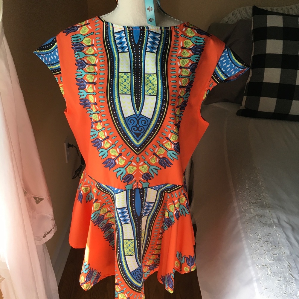 Colorful orange print  poly blouse, with  cap sleeves and back zipper.